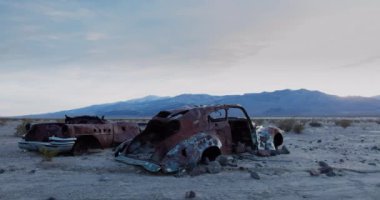 A time-lapse of sunset in the Panamint Valley in Death Valley National Park, California. Old rusted cars are in the foreground, the Argus Range in the background.