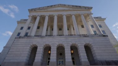 The north side entrance to the Longworth House Office Building on Capitol Hill in Washington D.C. as seen from Independence Avenue on a spring day. Low-angle wide shot. No people.