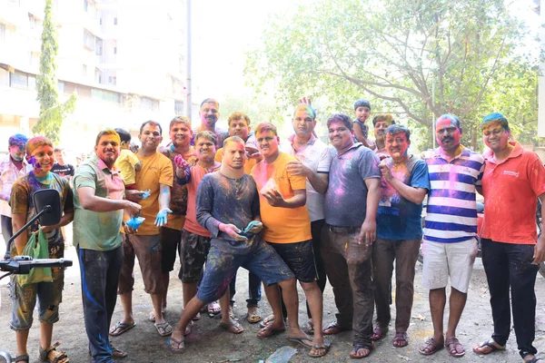 Dombivali, Thane, India - 09 March 2020 : Holi celebration. Friends celebrating the festival of colours. Colourfull editorial photo. Painted faces. Smiling and happy people.