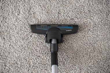 brushes from a vacuum cleaner on a gray rug