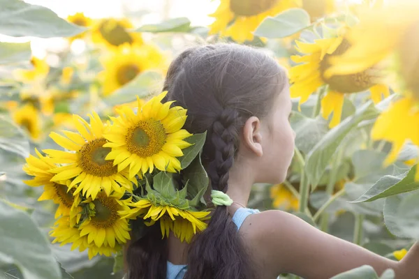 young woman with sunflower in her hands.portrait of a beautiful girl with sunflower in the field