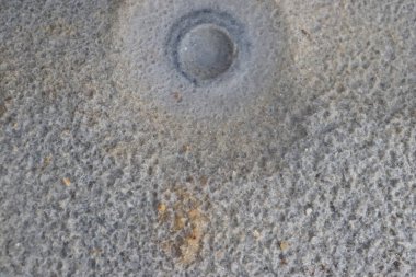 White sand with a pattern formed by rain drops