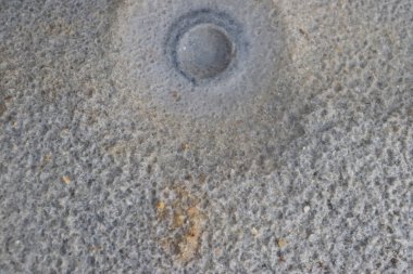 White sand with a pattern formed by rain drops