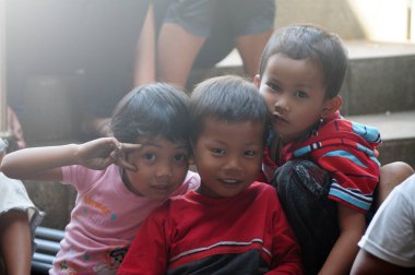 Solo, Indonesia - November 2012, Local children pose happily in front of the camera. Simple happiness