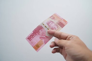 Hands and Rupiah isolated on a white background