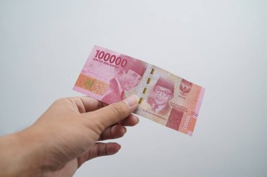 Hands and Rupiah isolated on a white background