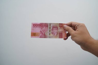 Hands and Rupiah isolated on a white background