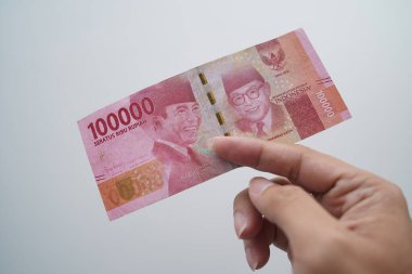 Hands and Rupiah isolated on a white background