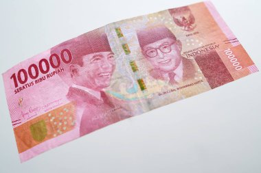Close up of the 100 thousand rupiah banknote. Close up view of Soekarno and Hatta faces on the front of banknotes.