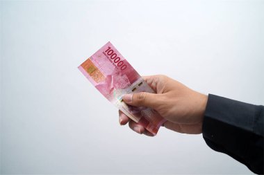 Hands and Rupiah isolated on a white background