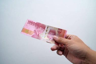 Hands and Rupiah isolated on a white background