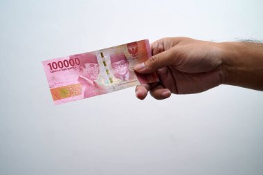 Hands and Rupiah isolated on a white background