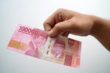 Hands and Rupiah isolated on a white background