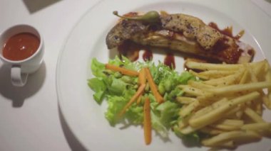 Grilled salmon fillet steak with french fries and vegetables - healthy food style
