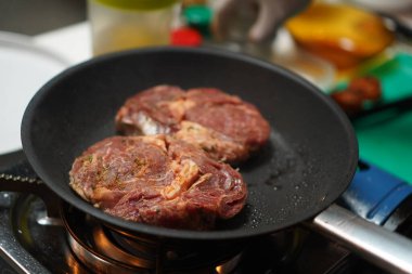 Cooking delicious beef steak in frying pan