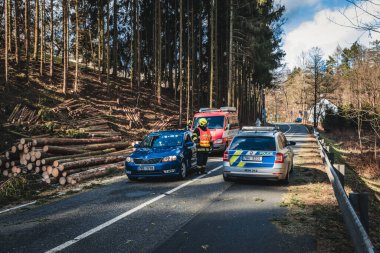 firefighters on the road, cutting fallen trees, the way to the forest.