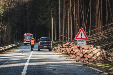 İtfaiyeciler yolda, devrilmiş ağaçları kesiyorlar, ormana giden yol....