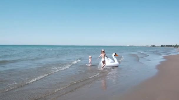 Kinderen Bij Zee Spelen Met Een Opblaasbare Zwaan Langs Kust — Stockvideo