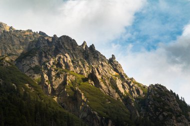 Polonya 'daki Tatra Ulusal Parkı' ndaki dağların manzarası. Bulutlarda parlayan inanılmaz güneş.