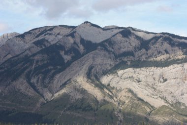 A cascade of mountains on a cloudy day.