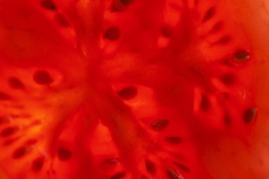 Tohumlu yarım doğranmış domates diliminin Macro fotoğrafı. Domates dilimi dokusu. 