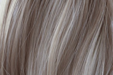 Gray curly hair texture closeup. Light gray hair background.
