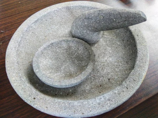 Traditional mortar and pestle made of stone used for grinding spices