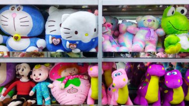 various cute dolls on display on toy store shelves