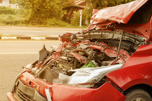 the car is a broken and a damaged hood