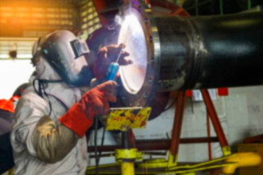 worker in protective mask welding equipment