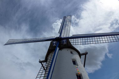 Traditional windmill against blue sky and cloud in Northern France