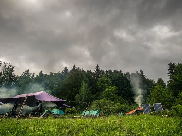 Mountain camp, where people live in houses with domes, rejecting life in cities and the culture that is present in them. People use green energy and breed animals