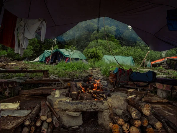 Mountain camp, where people live in houses with domes, rejecting life in cities and the culture that is present in them. People use green energy and breed animals