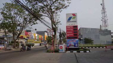 Bandung, indonesia - 20 July 2022 : Pertamina nameplate from a distance. Indonesian gas station company.
