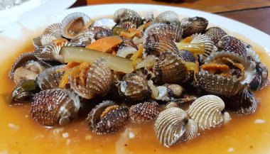 Tatlı ve ekşi deniz tarakları, işlenmiş taze kabuklu deniz ürünleri, acı biber sosu, domates, zencefil, bombay, sarımsak ve istiridye sosuyla pişirilmiş bir yemektir.