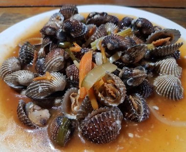 Tatlı ve ekşi deniz tarakları, işlenmiş taze kabuklu deniz ürünleri, acı biber sosu, domates, zencefil, bombay, sarımsak ve istiridye sosuyla pişirilmiş bir yemektir.