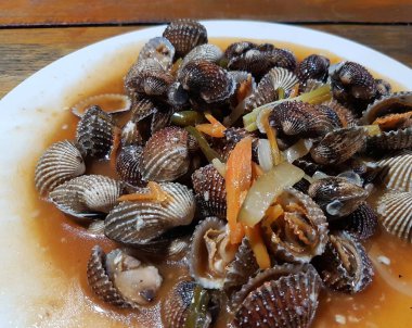 Tatlı ve ekşi deniz tarakları, işlenmiş taze kabuklu deniz ürünleri, acı biber sosu, domates, zencefil, bombay, sarımsak ve istiridye sosuyla pişirilmiş bir yemektir.