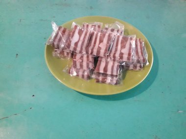 Yeşil tabakta çikolata ve beyaz katlı kek.