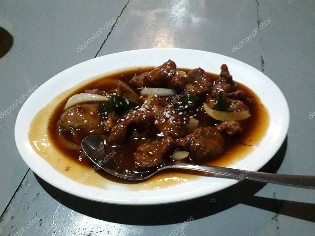 japanese food spicy teriyaki beef steak dish, beef in spicy sauce with mushrooms, close up view