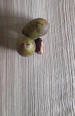 Matoa fruit from Papua, Indonesia. Matoa contains vitamins, nutrients and antioxidants. Served in wooden background, selective focus image, copy space.