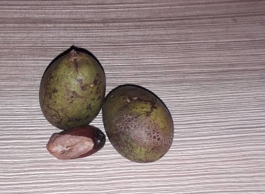 Matoa fruit from Papua, Indonesia. Matoa contains vitamins, nutrients and antioxidants. Served in wooden background, selective focus image, copy space.