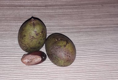 Matoa fruit from Papua, Indonesia. Matoa contains vitamins, nutrients and antioxidants. Served in wooden background, selective focus image, copy space.