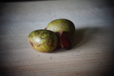 Matoa fruit from Papua, Indonesia. Matoa contains vitamins, nutrients and antioxidants. Served on wooden background, selective focus image, copy space.