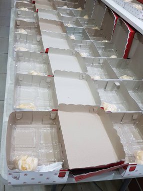 Stack of pizza boxes. Cardboard brown boxes for shipping and delivery of pizza. Many packaging is on the kitchen stock. Food order and delivering concept. Front view.