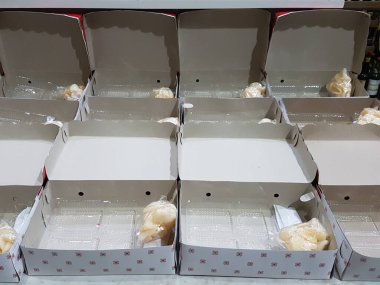 Stack of pizza boxes. Cardboard brown boxes for shipping and delivery of pizza. Many packaging is on the kitchen stock. Food order and delivering concept. Front view.