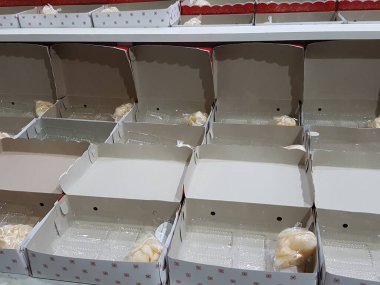 Stack of pizza boxes. Cardboard brown boxes for shipping and delivery of pizza. Many packaging is on the kitchen stock. Food order and delivering concept. Front view.