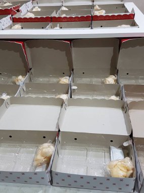 Stack of pizza boxes. Cardboard brown boxes for shipping and delivery of pizza. Many packaging is on the kitchen stock. Food order and delivering concept. Front view.