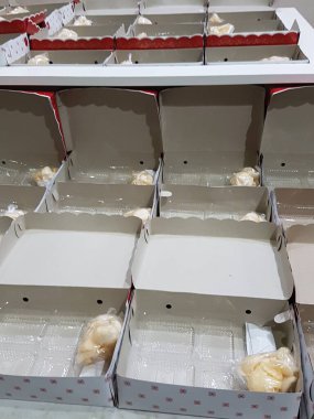 Stack of pizza boxes. Cardboard brown boxes for shipping and delivery of pizza. Many packaging is on the kitchen stock. Food order and delivering concept. Front view.