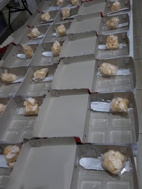 Stack of pizza boxes. Cardboard brown boxes for shipping and delivery of pizza. Many packaging is on the kitchen stock. Food order and delivering concept. Front view.