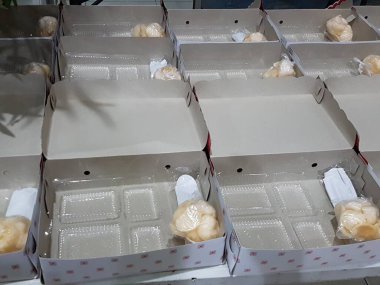 Stack of pizza boxes. Cardboard brown boxes for shipping and delivery of pizza. Many packaging is on the kitchen stock. Food order and delivering concept. Front view.